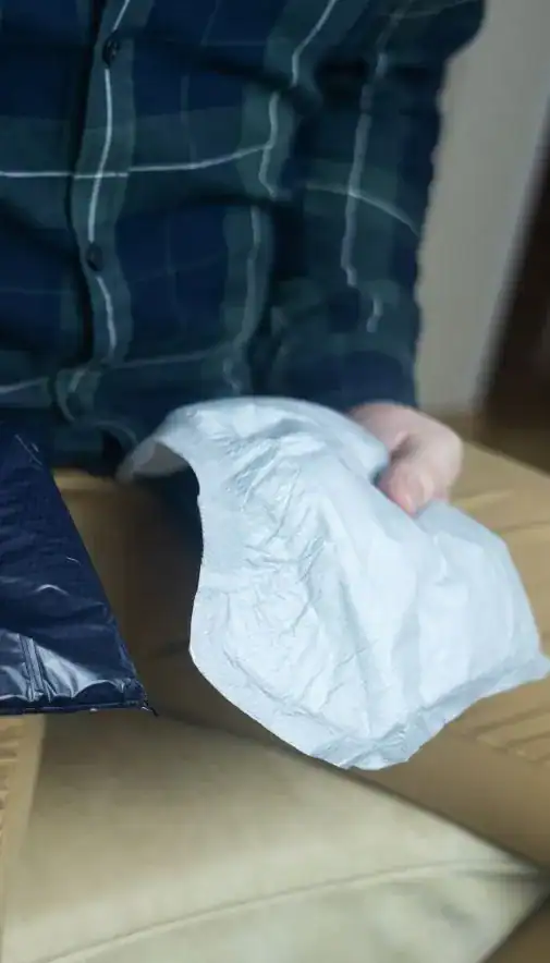 Image of man holding incontinence pads as part of overactive bladder treatment London