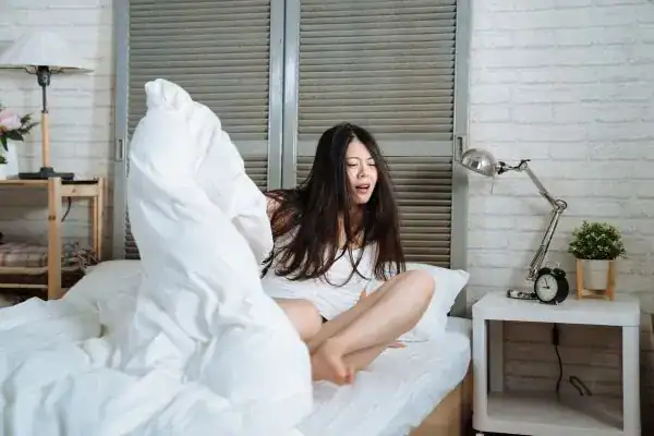 Image of woman getting up because of nighttime leaks London